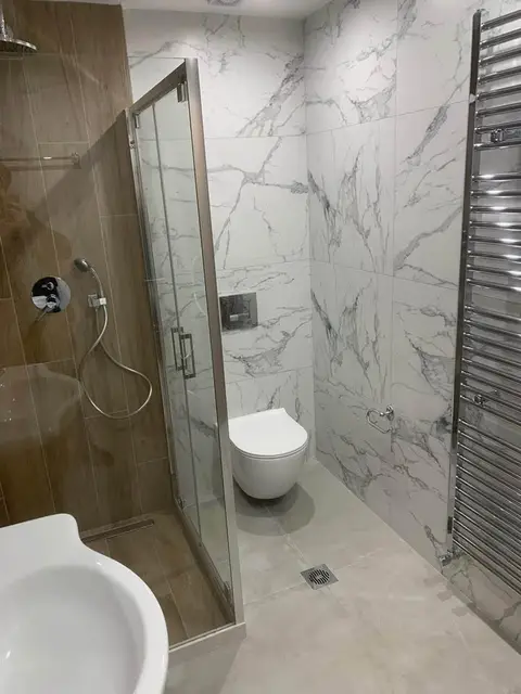 The renovated three-bedroom: one of the two bathrooms, with a glass shower