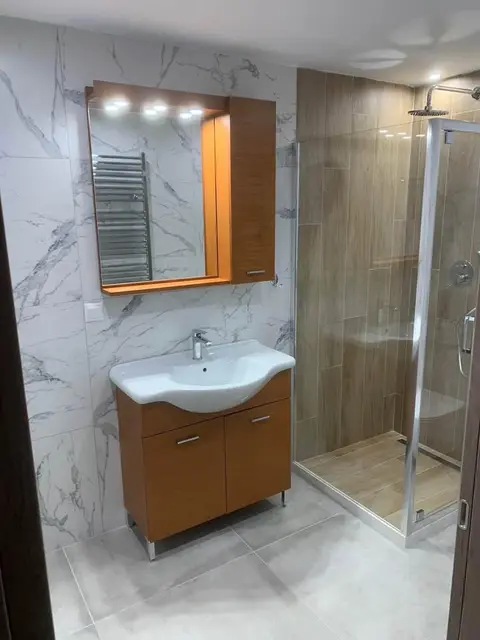 The renovated three-bedroom: the second bathroom, with a vanity unit and a shower